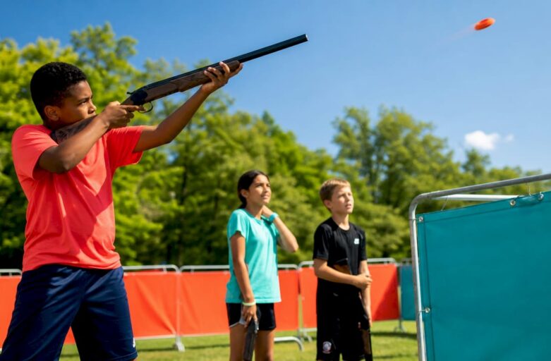 Children participating in safe laser clay shooting outdoors