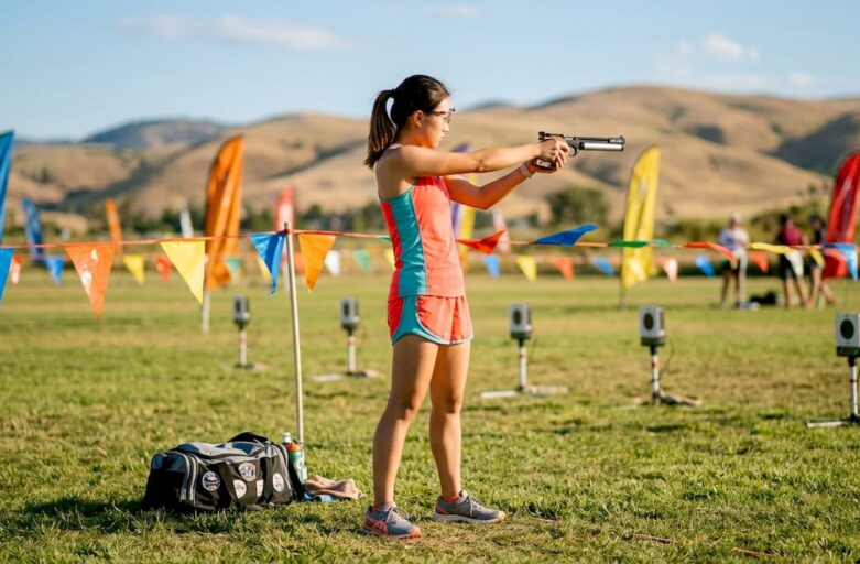 Athlete practicing laser sport shooting indoors