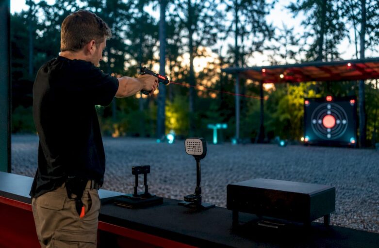 Shooter practicing with laser pistol in training lane