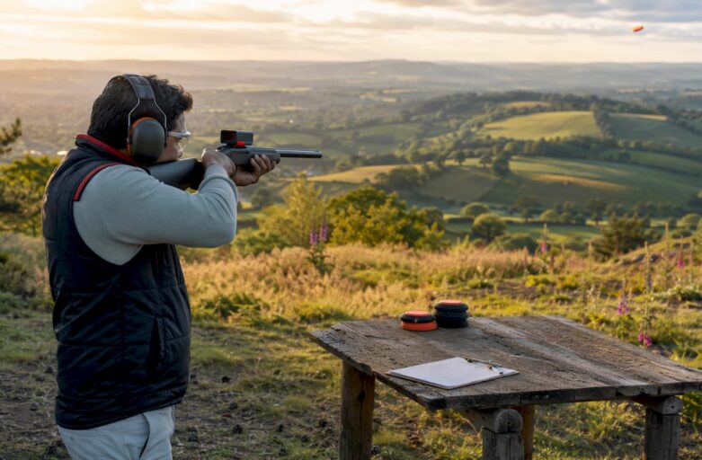 Man shooting eco-friendly laser clay targets outdoors