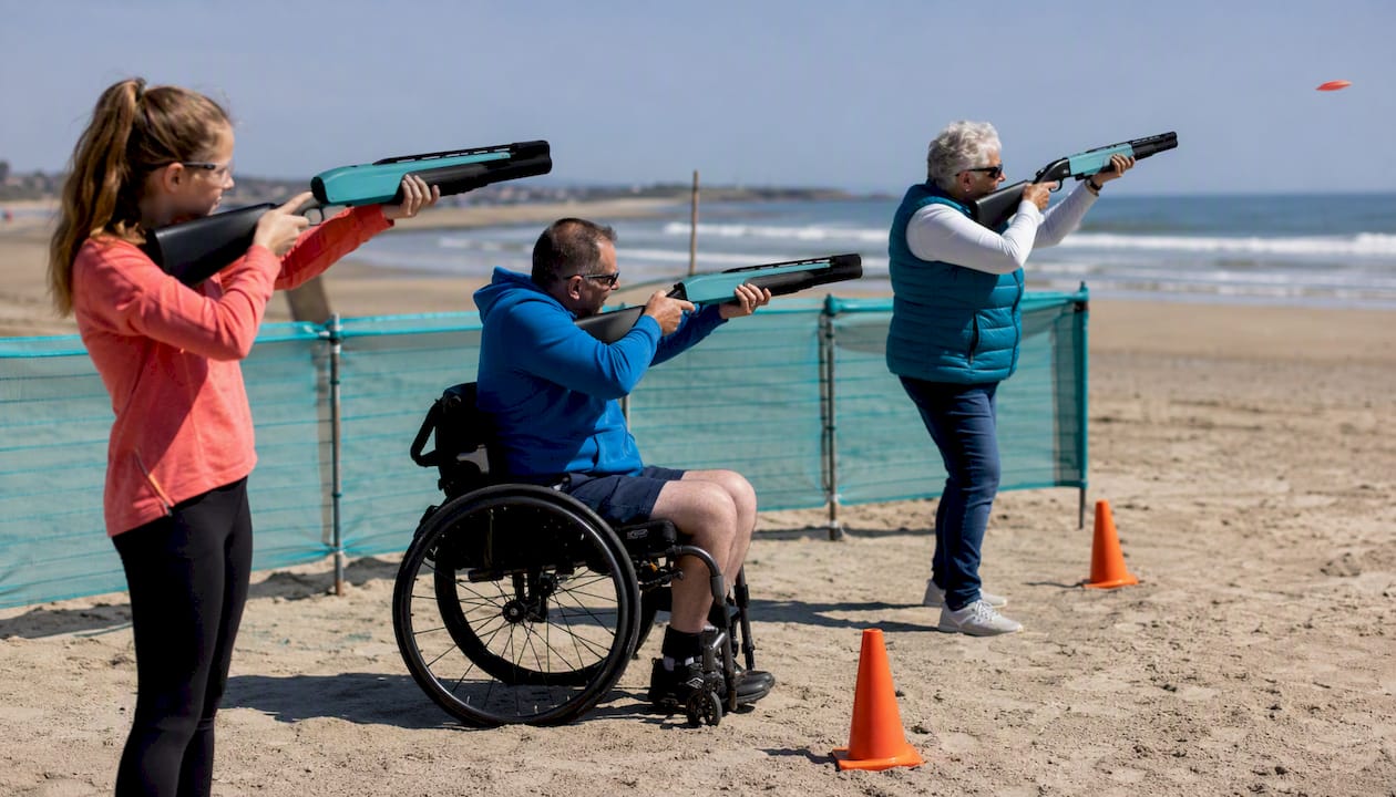 Diverse group engaging in laser clay shooting outdoors