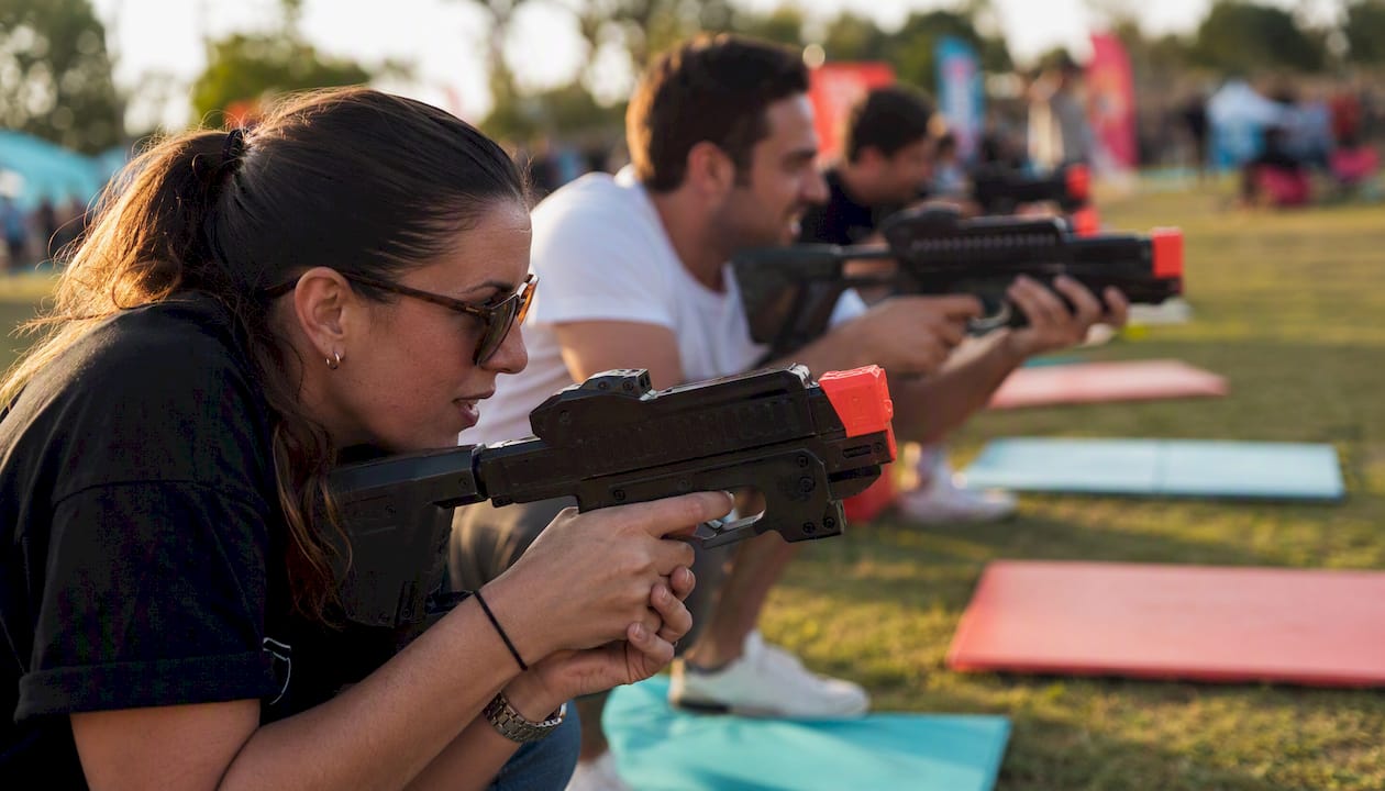 Group enjoying laser clay shooting indoors