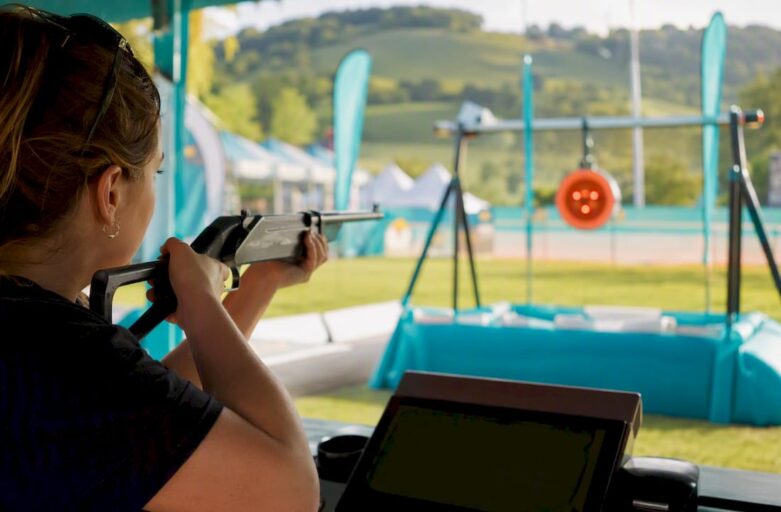 Hands aiming laser clay shooting device outdoors