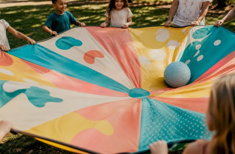 Hands holding parachute passing ball outdoors