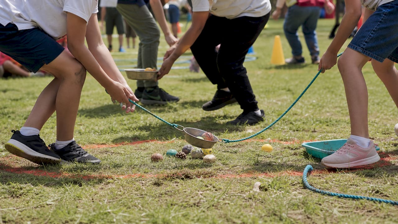 Hands using tools in outdoor treasure transport game