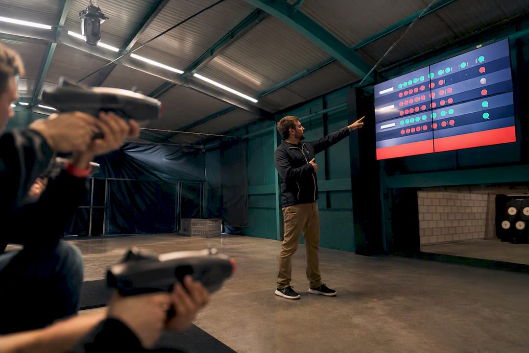 Hands holding laser gun aiming with live laser clay scores