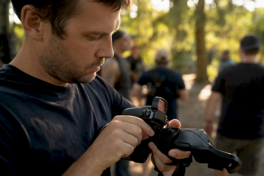 Hands adjusting laser gun sensor at event