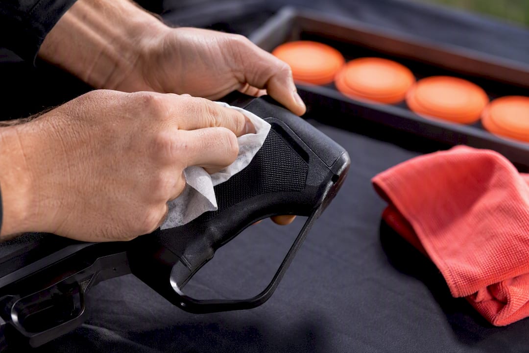 Hands cleaning shared laser clay equipment
