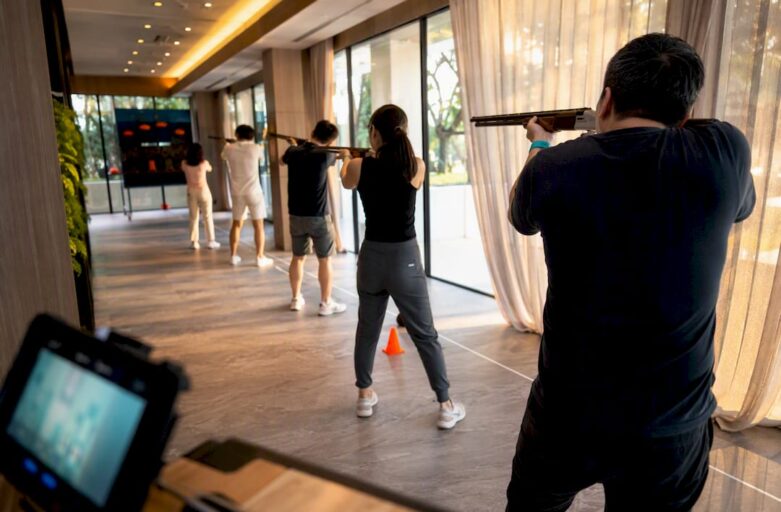 Team playing laser clay indoors