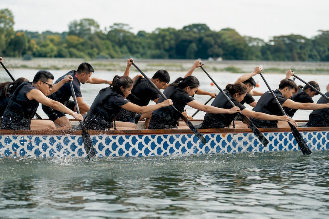 Dragon boat crew paddling in formation