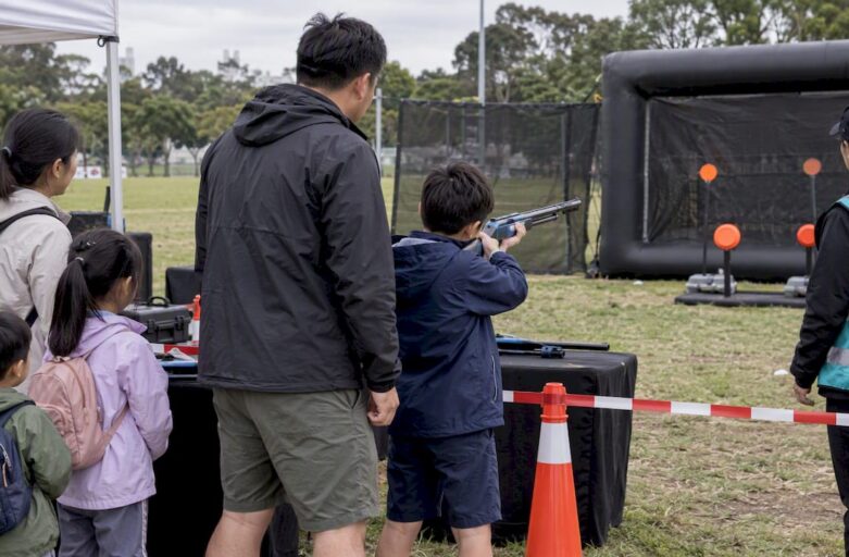 Family taking part in supervised laser clay