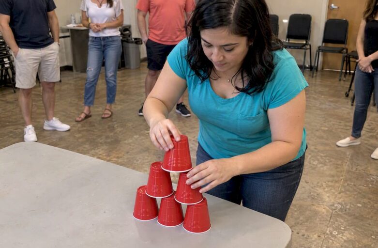 Guest stacking cups at a party game station