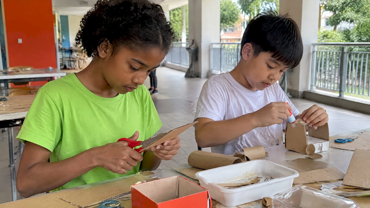 Pupils making crafts from reused cardboard